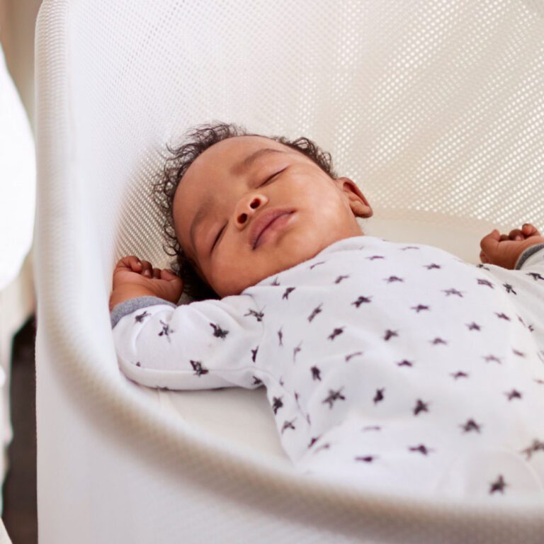 Baby sleeping peacefully in a bassinet