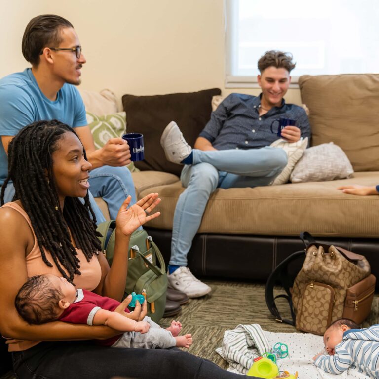 Group of happy new parents socializing in the Community Learning Center
